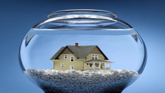 A house is in the bottom of a fish bowl.