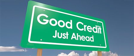 A green sign that says " good credit just ahead ".